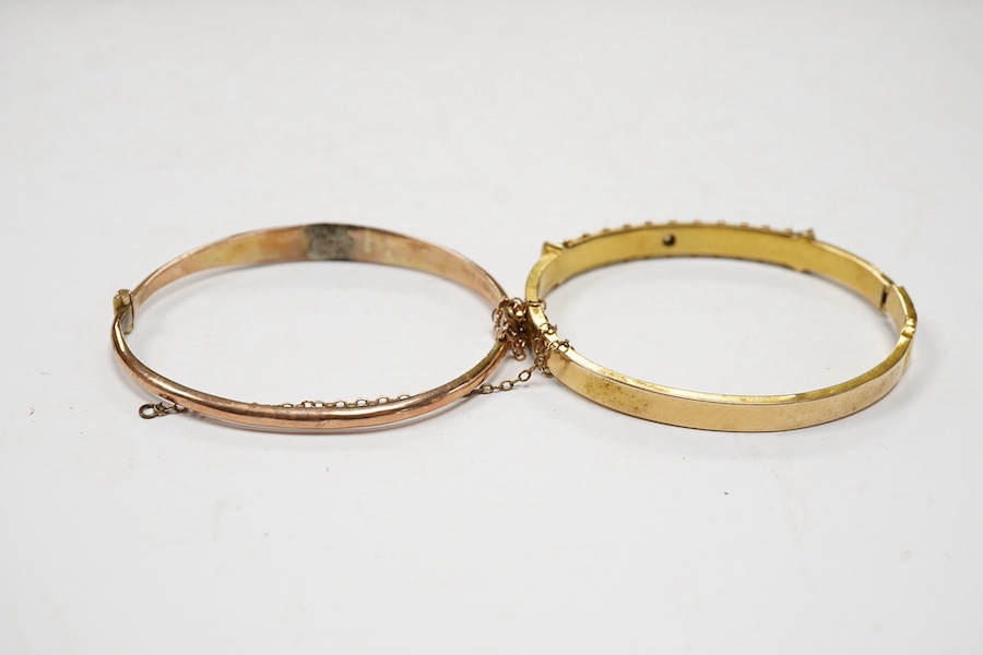 An Edwardian yellow metal, diamond and seed pearl set hinged bangle and one other late Victorian engraved 9ct gold hinged bangle, both a.f., gross weight 14.6 grams. Condition - poor